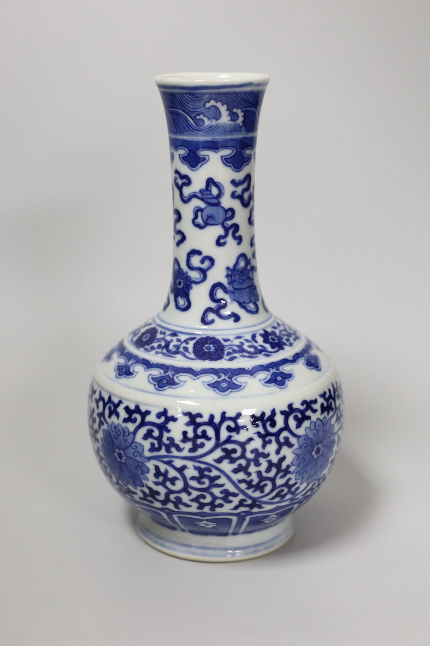 A late 19th century Chinese blue and white ‘eight Buddhist emblems’ vase, apocryphal Kangxi mark, 23cm